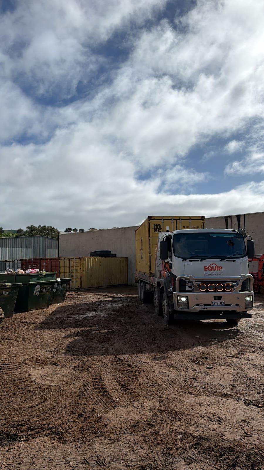 Shipping container loaded on Equip Hire tilt tray at Adelaide container yard