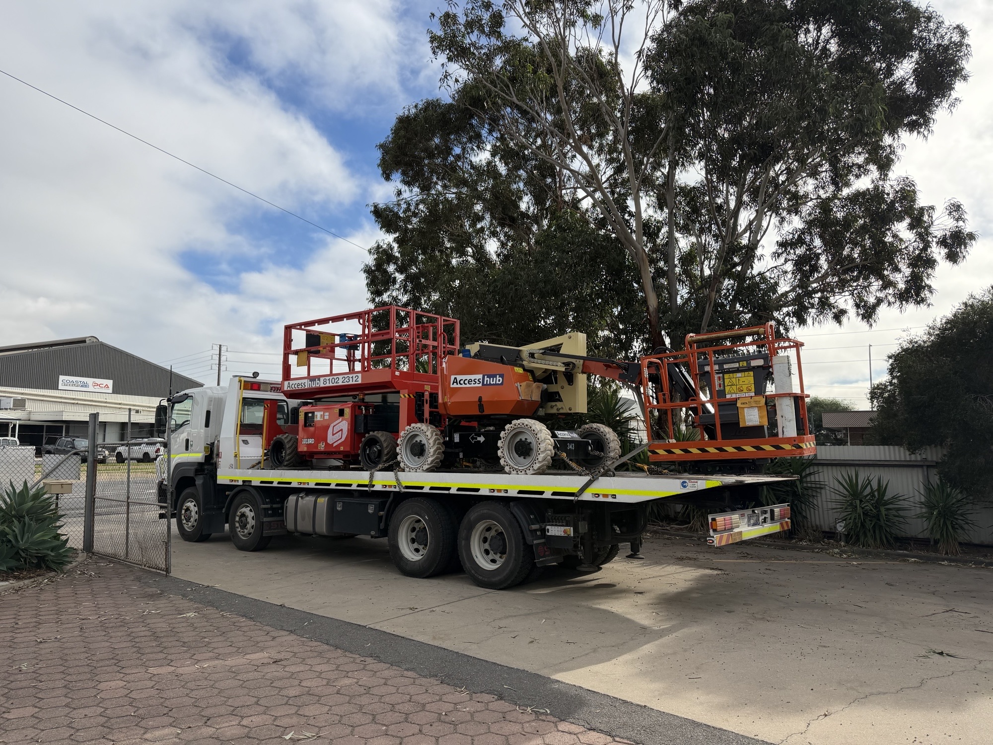 Boom lifts and EWPs loaded on tilt tray for Adelaide transport
