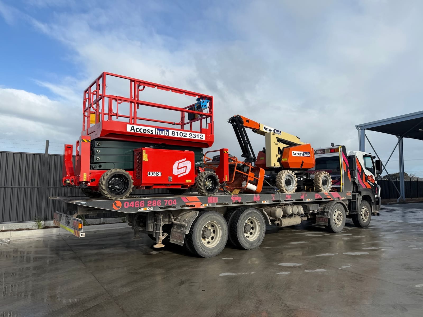 Scissor lift and boom lift loaded on tilt tray for EWP transport in Adelaide