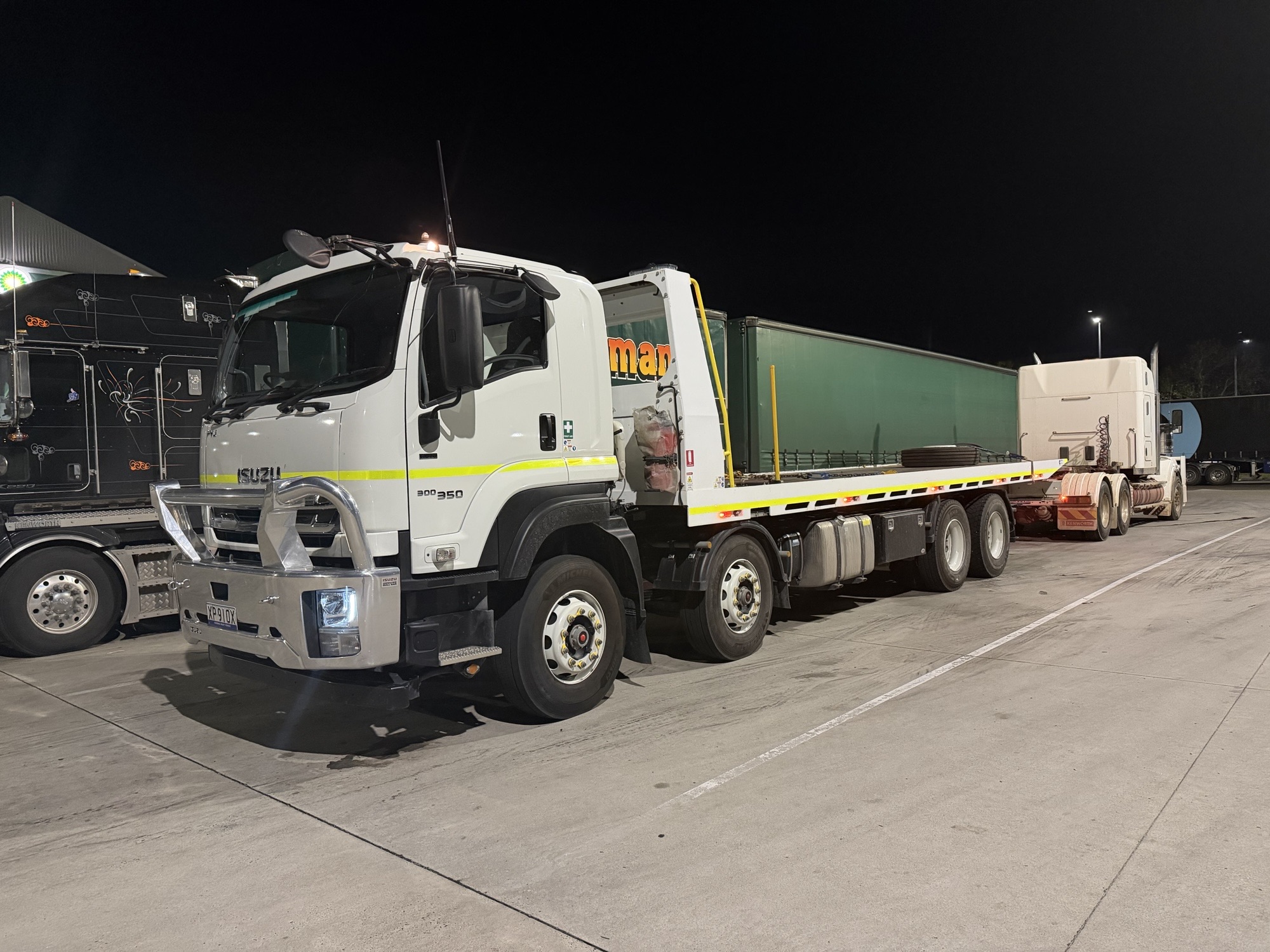 Isuzu FYJ 300-350 8x4 tilt tray at logistics yard